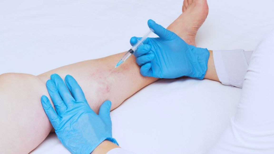 A person receives an injection in their leg, possibly as part of peptide therapy for recovery.