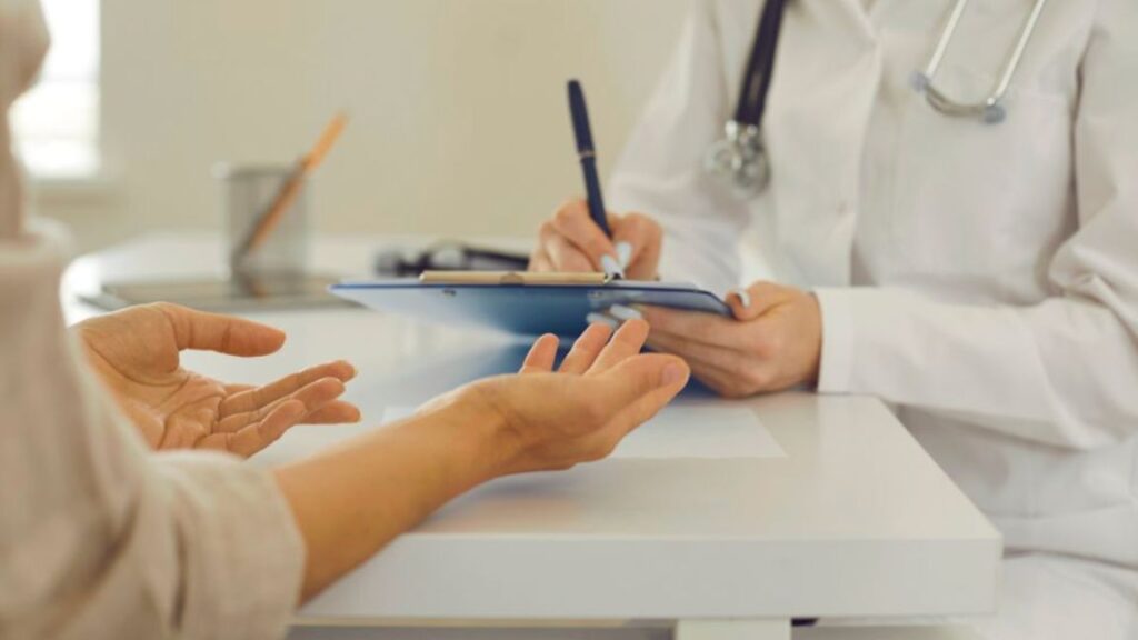 A functional medicine doctor speaks with a patient, emphasizing a holistic approach to health and wellness in a medical office.