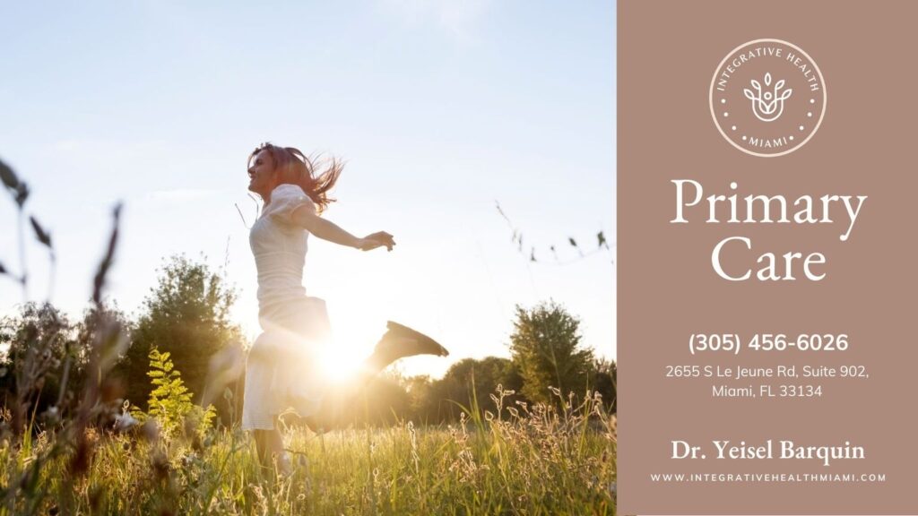 A woman running freely in a sunlit field, symbolizing the wellness and vitality promoted by primary care and integrative health approaches.