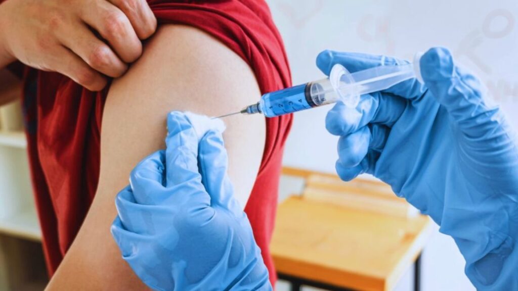 Healthcare professional administering recovery peptides injection into a patient’s upper arm in a clinical setting.