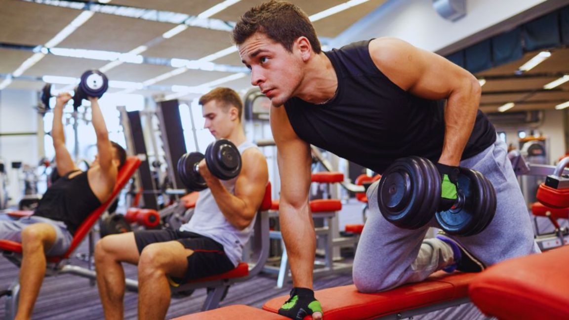 Men performing strength training as part of a men’s wellness-focused fitness routine.