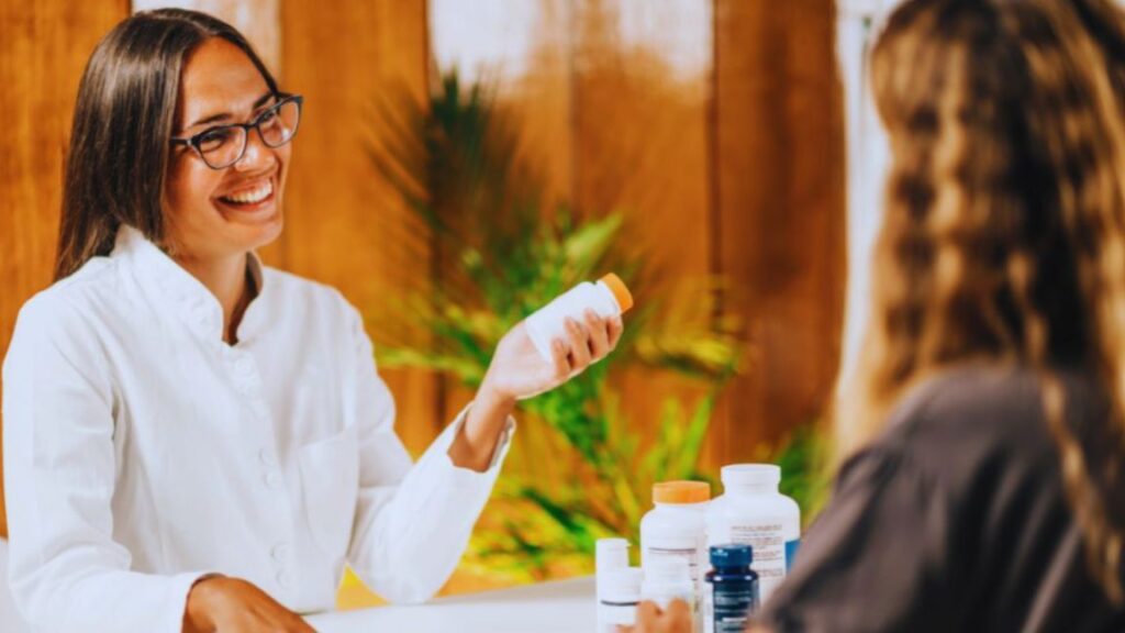 Functional medicine practitioner speaking with a patient during a wellness consultation at a modern clinic.