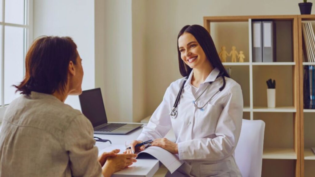 Reproductive endocrinologist in Miami consulting with a patient in a private medical office.